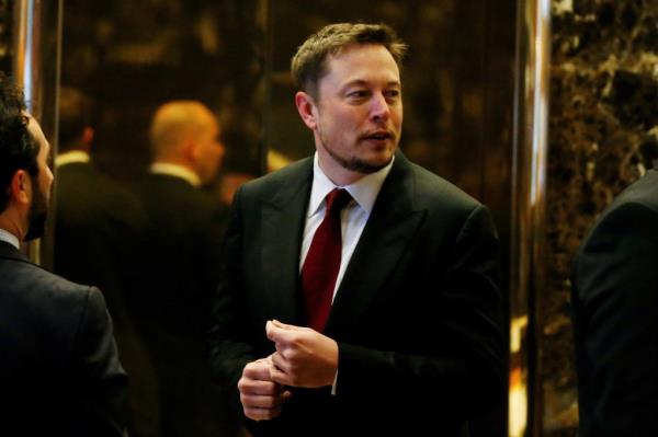 Tesla CEO Elon Musk in a suit and tie, entering the lobby of Trump Tower in Manhattan, New York, on January 6, 2017.
