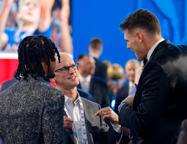 UCONN head coach Dan Hurley (C) talks to former players Stephon Castle (L) and teammate Do<em></em>novan Culligan (R) before the start of the 2024 NBA Draft at the Barclays center at the Barclays Center in Brooklyn, New York on June 26, 2024.