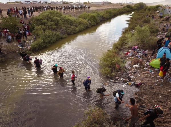 Large group of migrants crossing the U.S.-Mexico Border at the Rio Grande river in El Paso, Texas on October 3, 2023