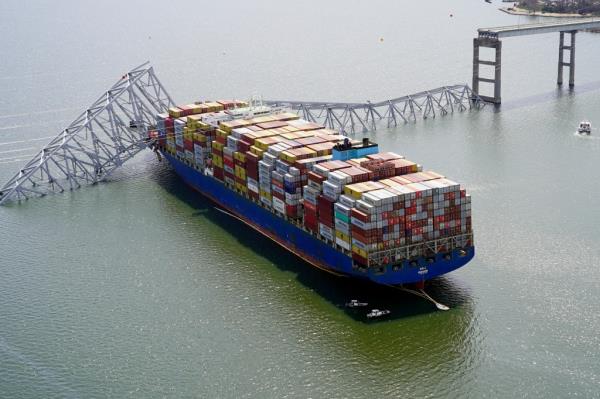 In this aerial image released by the Maryland Natio<em></em>nal Guard, the cargo ship Dali is stuck under part of the structure of the Francis Scott Key Bridge after the ship hit the bridge, Tuesday, March 26, 2024.