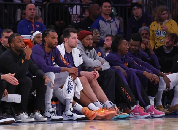 Suns forward Kevin Durant (35) sits on the bench in plain clothes during the second half when the New York Knicks played the Phoenix Suns