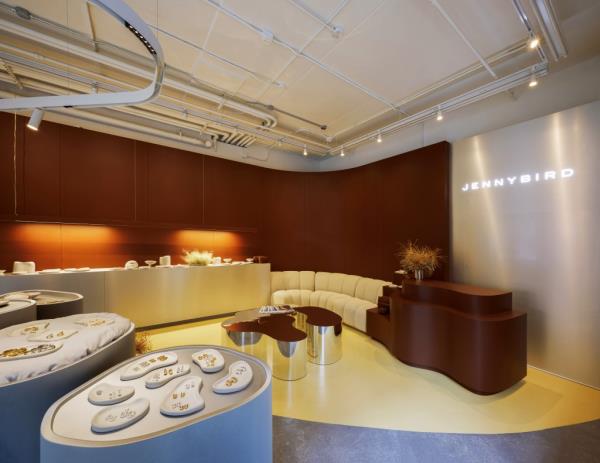 Interior of Jenny Bird's pop-up store in Nolita, featuring a couch and a table