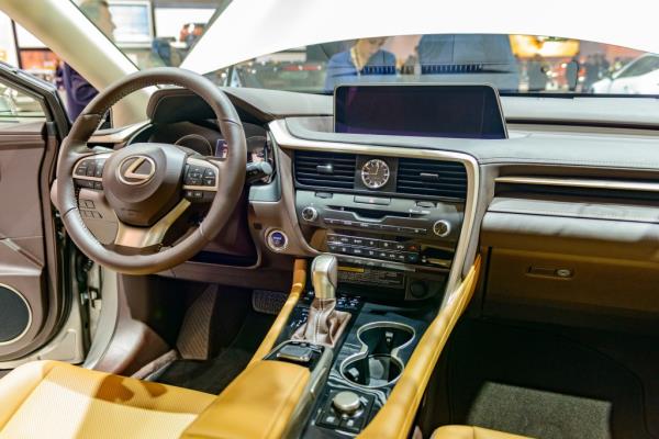 Interior of a Lexus RX450h hybrid SUV with tanned leather seats and information displays on dashboard on display in Brussels Expo.