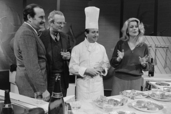 Michel Guérard receives the Medal of Merit in front of author Jean Ferniot and actress Catherine Deneuve, 1980. 