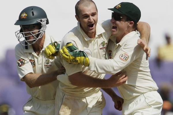 Jason Krejza, centre, one of the coaches affected by the company’s collapse, celebrates after dismissing Indian batsman Rahul Dravid during a Test match in Nagpur in 2008.