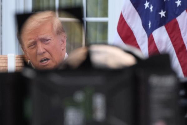 Republican presidential nominee former President Do<em></em>nald Trump, seen through a television lens as he speaks.