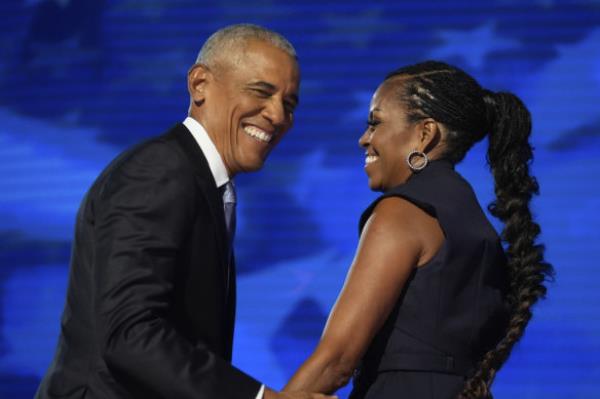 Former US president Barack Obama with former first lady Michelle Obama as he is introduced during the Democratic Natio<em></em>nal Co<em></em>nvention in Chicago. 