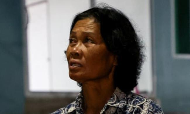 Noopar Pansa-ard, 63, holds up a picture of her son, Somkuan Pansa-ard, 39