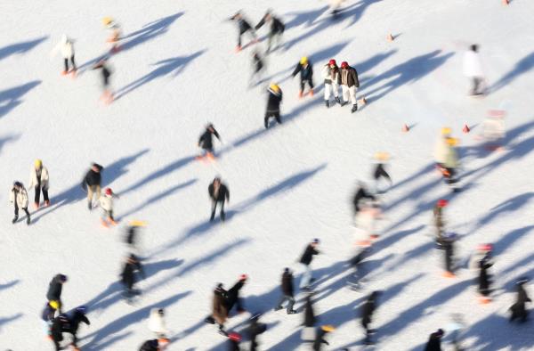 Visitors enjoy ice skating at an outdoor rink set up at Seoul Plaza in downtown Seoul on Sunday. (Yonhap)
