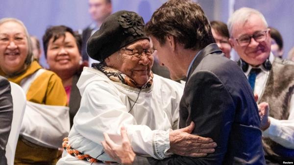 Canada’s Prime Minister Justin Trudeau, right, is greeted by an elder during a devolution ceremony at the Aqsarniit Hotel & Co<em></em>nference Centre in Iqaluit, Nunavut, Canada, Jan. 18, 2024.