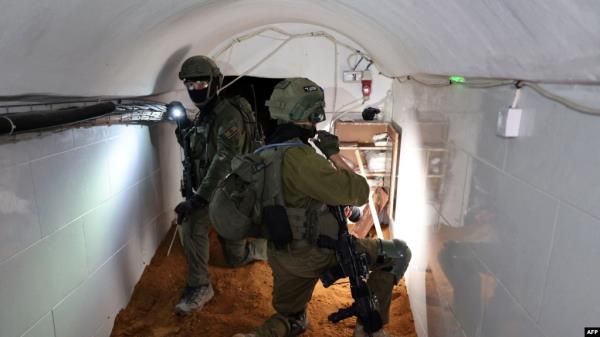 This photo, taken during a Feb. 8, 2024, media tour organized by the Israeli military, shows Israeli soldiers inside a tunnel that the army claims is a 