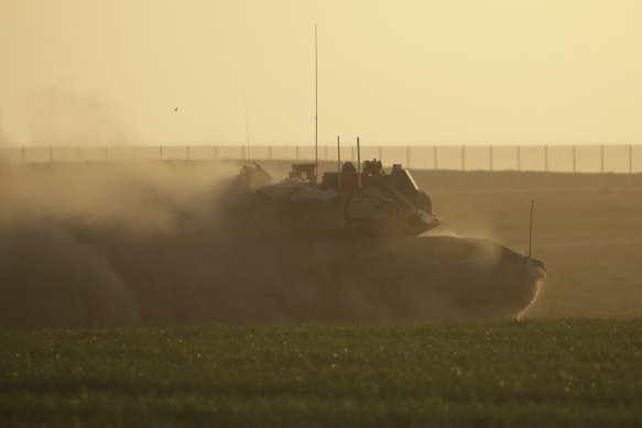 An Israeli tank moves near the border with the Gaza Strip in southern Israel. 