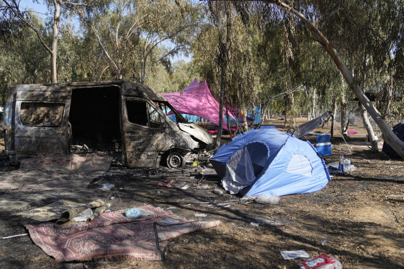 Tents, debris and a burned out van are scattered a<em></em>bout the site of a music festival near the border with the Gaza Strip days after October 7.