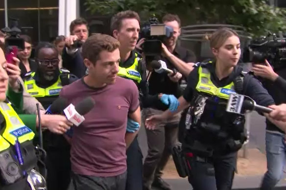 The climber was escorted by police from the CBD building o<em></em>nce he reached the top.