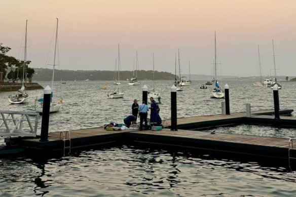 Emergency perso<em></em>nnel attend to the woman who was attacked by a shark.