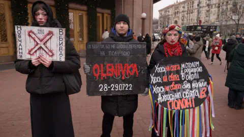 BBC People are seen protesting for the return of priso<em></em>ners of war