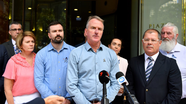 Andrew Prestney (centre), the father of Co<em></em>nstable Josh Prestney, outside the Downing Centre Local Court on Tuesday.