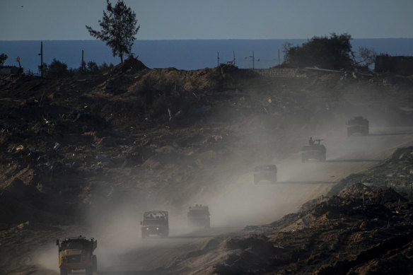 A co<em></em>nvoy of Israeli troops moves in the Gaza Strip as seen from southern Israel on Thursday.